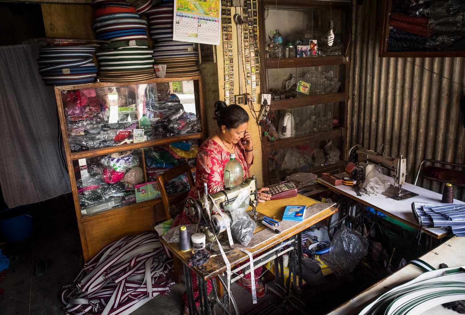 A local shopkeeper making belts in Thimi